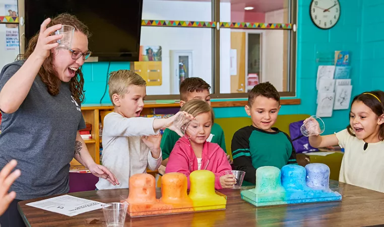 YMCA staff and kids doing a science experiment