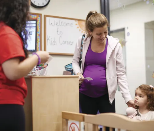 mother drops off child at Child Watch inside a YMCA