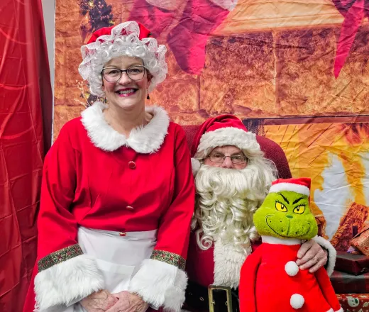 Jim and Nona dressed as Santa and Mrs. Clause for a YMCA holiday family event