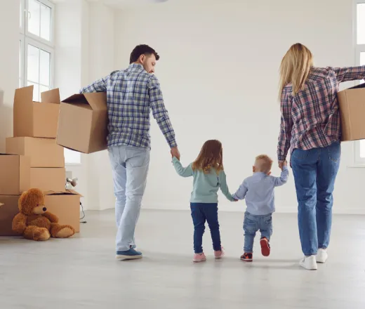 family moves boxes into new home