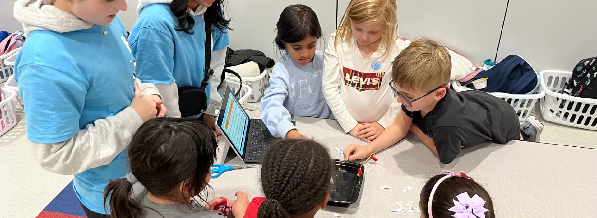 Kids and staff working on a project